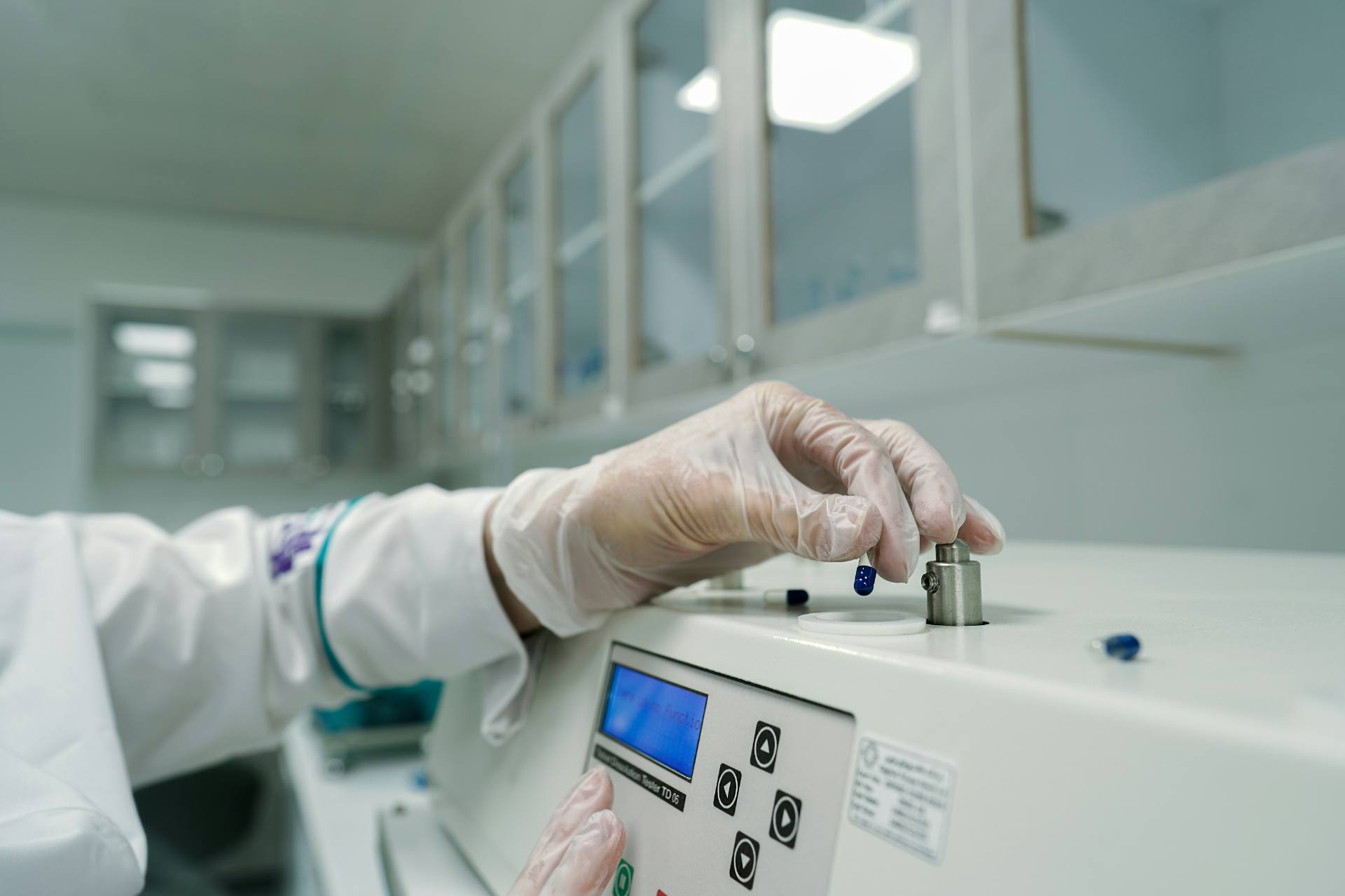 Scientist operating analytical laboratory equipment